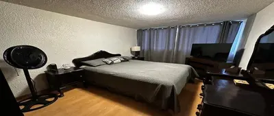 a bedroom with a bed and a flat screen tv at Alamos in Cordoba