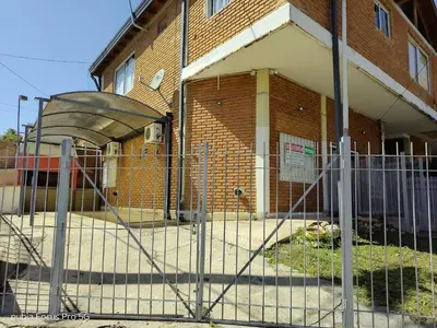 a fence in front of a brick building at Marcelina in Villa Carlos Paz