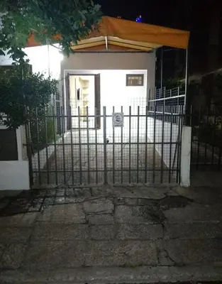 a gate in front of a house at night at La Pequeña Villa in Villa Carlos Paz