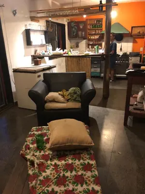 a living room with a couch with a pillow on a rug at Casa Kuku in Las Rabonas