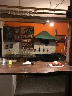 a kitchen with a table with fruits and vegetables on it at Casa Kuku in Las Rabonas