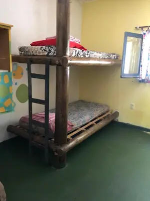 two bunk beds in a room with a green floor at Casa Kuku in Las Rabonas