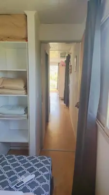 a hallway leading to a room with a bed and a corridor at Pasos del Dique in Cortaderas