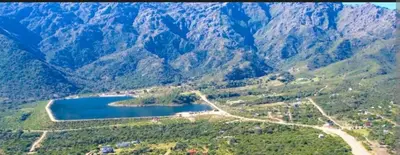 an aerial view of a mountain with a lake at Pasos del Dique in Cortaderas
