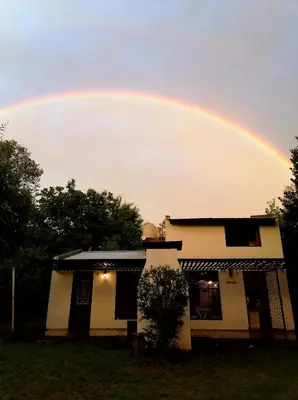a rainbow in the sky over a house at Casita Santa Elena 1 in Trapiche