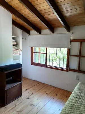 an empty room with a window and a couch at Casita Santa Elena 1 in Trapiche