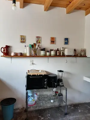 a kitchen with a toaster oven on a shelf at Casita Santa Elena 1 in Trapiche