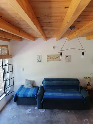 a blue couch in a room with a wooden ceiling at Casita Santa Elena 1 in Trapiche