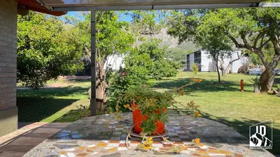 a vase filled with flowers sitting on a patio at Dos Soles in Cortaderas
