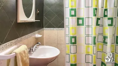 a bathroom with a sink and a shower curtain at Dos Soles in Cortaderas