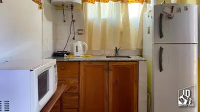 a kitchen with a white refrigerator and a microwave at Dos Soles in Cortaderas