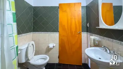 a bathroom with a toilet and a sink at Dos Soles in Cortaderas