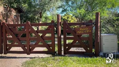 a wooden gate with a sign on it at Dos Soles in Cortaderas