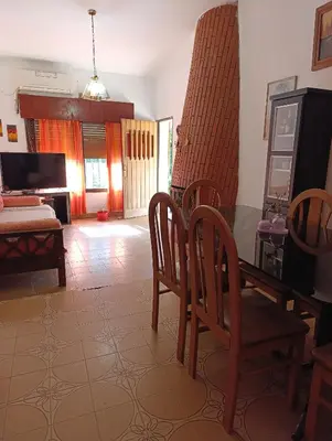 a living room with a dining room table and chairs at Casa Santa Rosa de Calamuchita in Cordoba