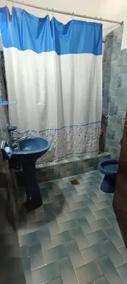 a bathroom with a sink and a shower curtain at Casa Santa Rosa de Calamuchita in Cordoba