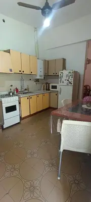 a kitchen with white appliances and a ceiling fan at Casa Santa Rosa de Calamuchita in Cordoba
