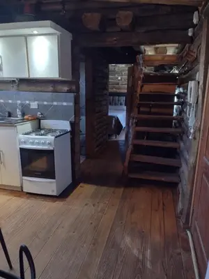 a kitchen with a stove and stairs in a cabin at Cabañas de San Antonio in San Antonio de Arredondo