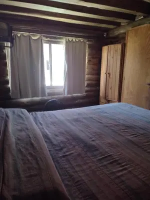a bedroom with a large bed and a window at Cabañas de San Antonio in San Antonio de Arredondo