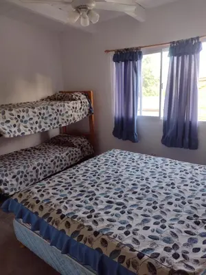 a bedroom with two bunk beds and a window at Cabañas de San Antonio in San Antonio de Arredondo