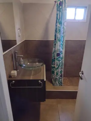 a bathroom with a glass sink and a shower at Cabañas de San Antonio in San Antonio de Arredondo