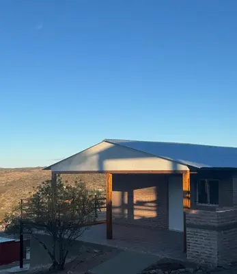 a house with a gambrel roof with a window at Balcones del Cristal - Tacuarita in Tanti