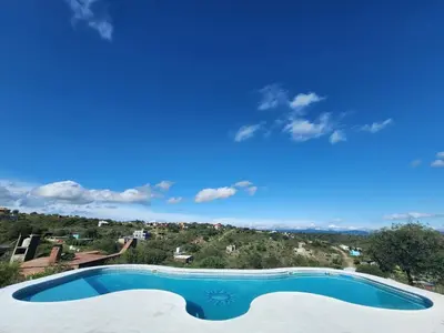 a swimming pool with a view of a mountain at Balcones del Cristal - Tacuarita in Tanti
