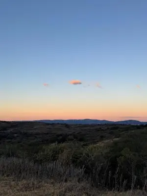 a view of the sunset from the top of a hill at Balcones del Cristal - Tacuarita in Tanti