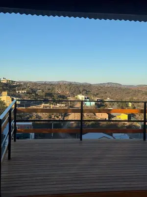 a boardwalk with a view of a city at Balcones del Cristal - Tacuarita in Tanti
