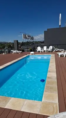 a swimming pool on the roof of a building at Departamento Premium en el corazón de Villa Carlos Paz in Villa Carlos Paz