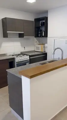 a kitchen with a sink and a counter top at Dpto Premium Frente al lago in Villa Carlos Paz