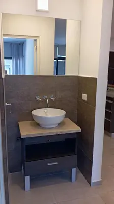 a bathroom with a sink and a mirror at Dpto Premium Frente al lago in Villa Carlos Paz