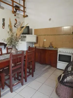 a kitchen with a table and chairs and a stove at Paraiso Cabañas in La Ramada
