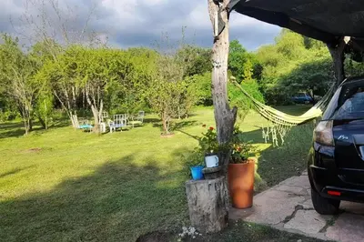 a garden with a hammock and a picnic table at Paraiso Cabañas in La Ramada