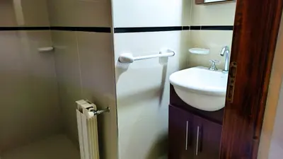 a small bathroom with a sink and a toilet at Departamento en el Centro Completo, Cochera, Pile, Pile Clim in Villa Carlos Paz