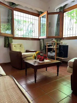 a living room with a couch and a coffee table at Paraíso in Mina Clavero