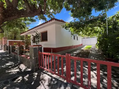 a house with a red fence in front of it at Paraíso in Mina Clavero
