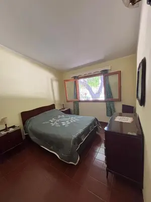 a bedroom with a large bed and a window at Paraíso in Mina Clavero