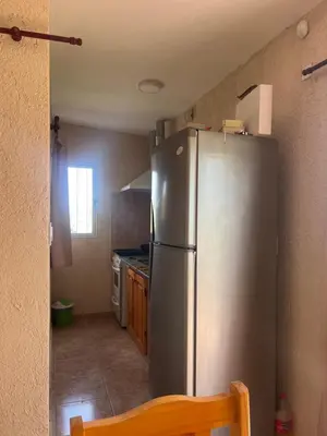 a kitchen with a stainless steel refrigerator in it at Cabaña hasta siete personas Complejo Aires de montaña siquiman in Villa Parque Siquiman