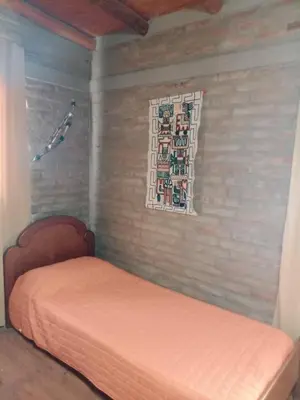 a bedroom with a bed and a window in it at Cabañas El Nirvana Villa Quillinzo in Villa Quillinzo