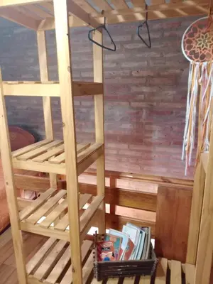 a ladder in a room with a book shelf at Cabañas El Nirvana Villa Quillinzo in Villa Quillinzo