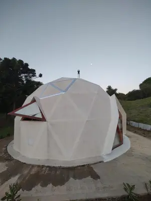 a large dome tent sitting on top of a field at Domo Bike in Villa Ciudad de America