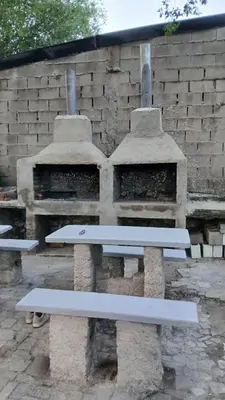 a white bench sitting next to a stone oven at Las Vertientes in Tanti