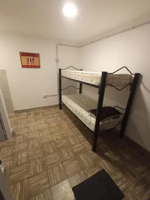 a room with two bunk beds and a wooden floor at Las Vertientes in Tanti