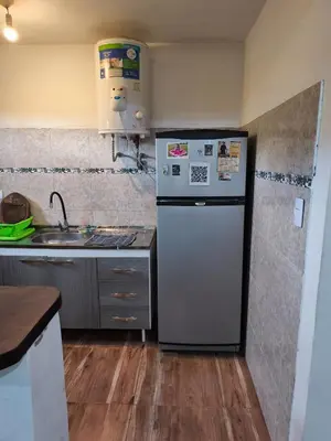 a kitchen with a refrigerator and a sink at Casa El Buen Descanso Cura Brochero in Villa Cura Brochero