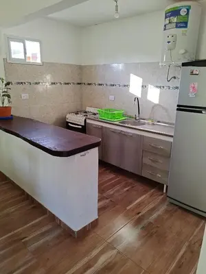 a kitchen with a sink and a stove and a refrigerator at Casa El Buen Descanso Cura Brochero in Villa Cura Brochero