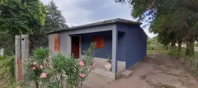 a small blue shed with a vase in front of it at El Tito Alojamiento in San Roque