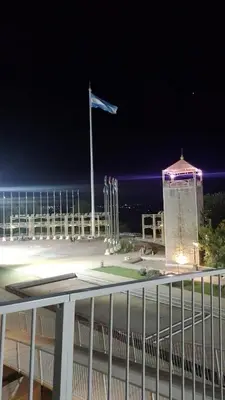 a flag on top of a building at night at El Tito Alojamiento in San Roque