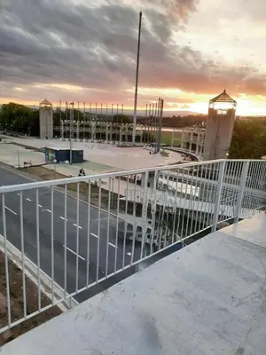 a white fence in front of a parking lot at El Tito Alojamiento in San Roque