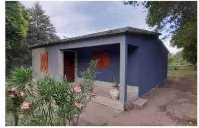 a blue house with a vase in front of it at El Tito Alojamiento in San Roque