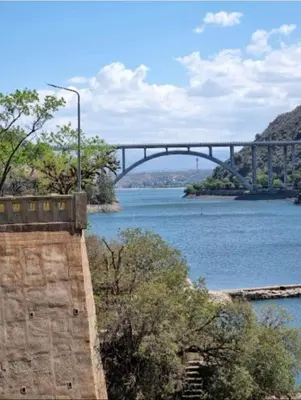 a bridge over a body of water with at El Tito Alojamiento in San Roque